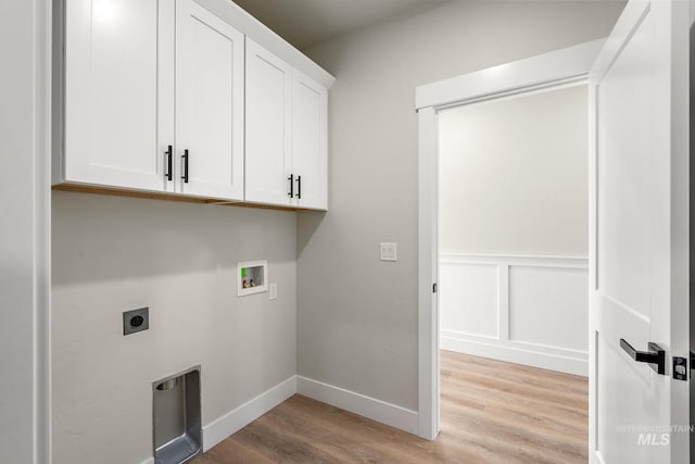 laundry area with electric dryer hookup, light wood-style flooring, cabinet space, a decorative wall, and hookup for a washing machine