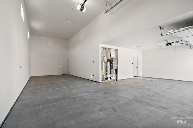 garage with a garage door opener and water heater