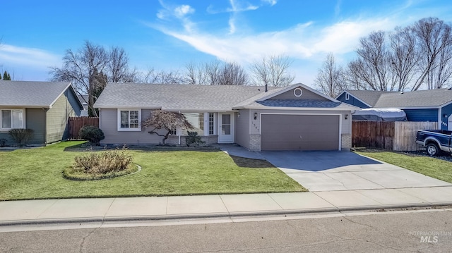 ranch-style home featuring driveway, fence, a front yard, an attached garage, and brick siding