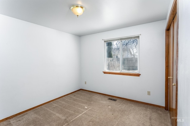 unfurnished bedroom featuring a closet, carpet flooring, baseboards, and visible vents