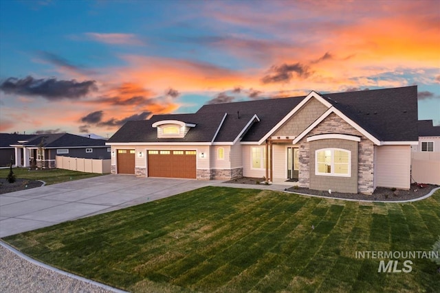 view of front of house with a garage and a yard