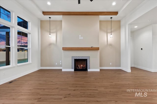 unfurnished living room featuring hardwood / wood-style flooring and a fireplace