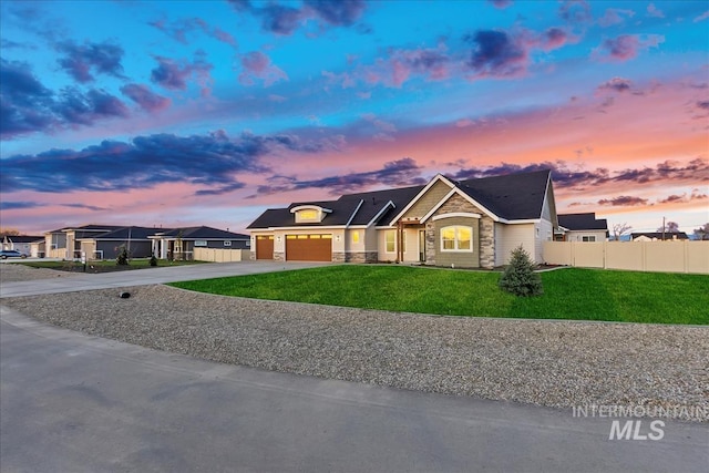 view of front of property featuring a yard and a garage