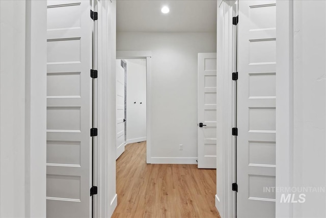 hall with light hardwood / wood-style floors