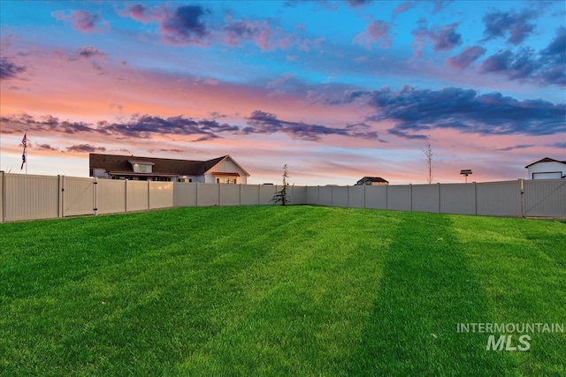 view of yard at dusk