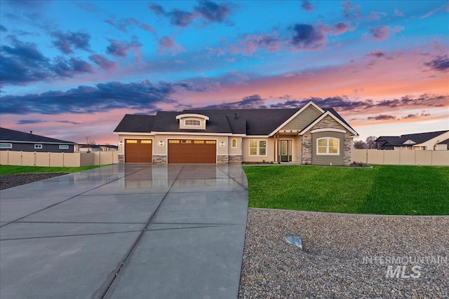 view of front of house featuring a lawn and a garage