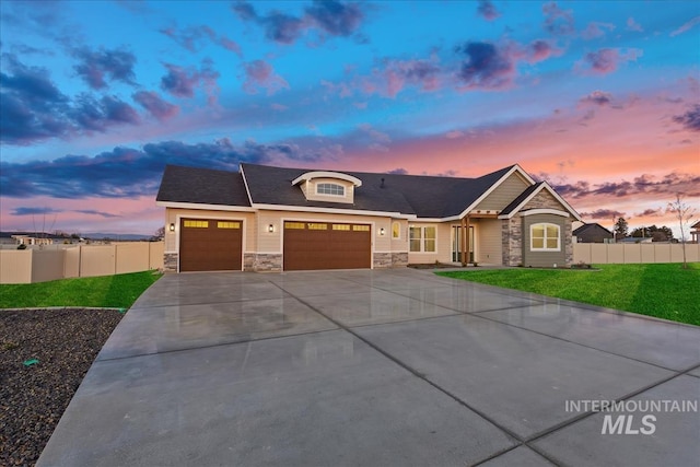 view of front of house featuring a garage and a yard