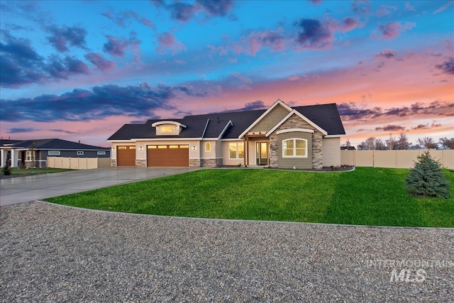 view of front of property featuring a garage and a yard