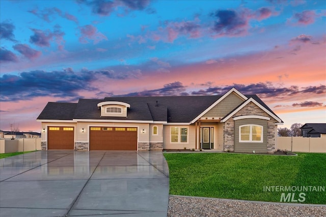 view of front of property with a yard and a garage