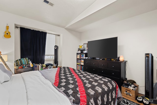 bedroom with lofted ceiling and visible vents