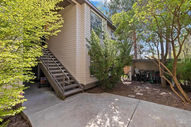 view of home's exterior with stairway and a patio area