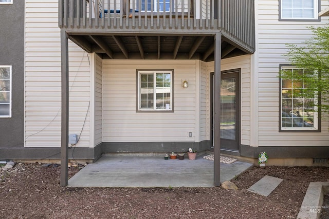 entrance to property with a patio area and a balcony