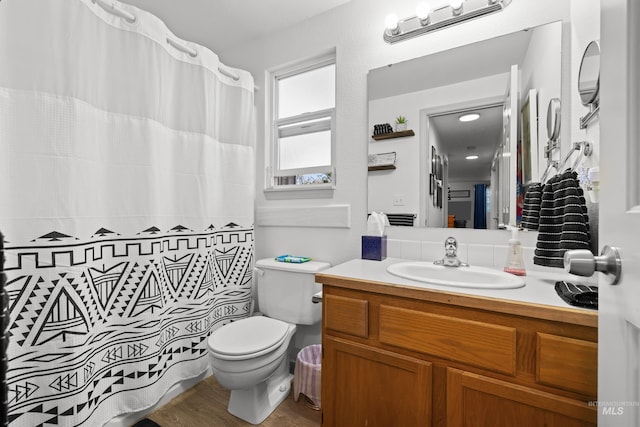 full bath with toilet, a shower with shower curtain, vanity, and wood finished floors