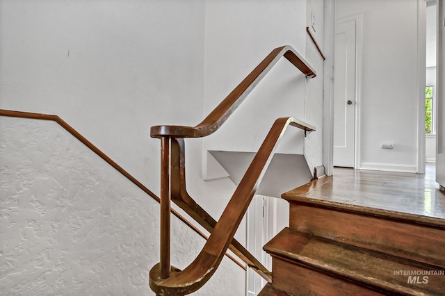 staircase featuring baseboards