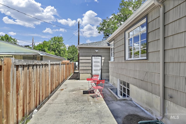 view of patio / terrace featuring entry steps and fence