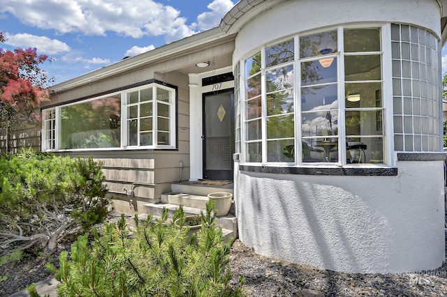 view of exterior entry with stucco siding