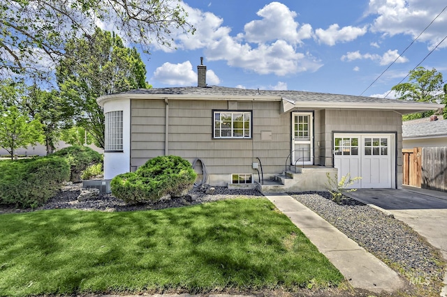 view of front of house featuring fence, an attached garage, a chimney, concrete driveway, and a front lawn