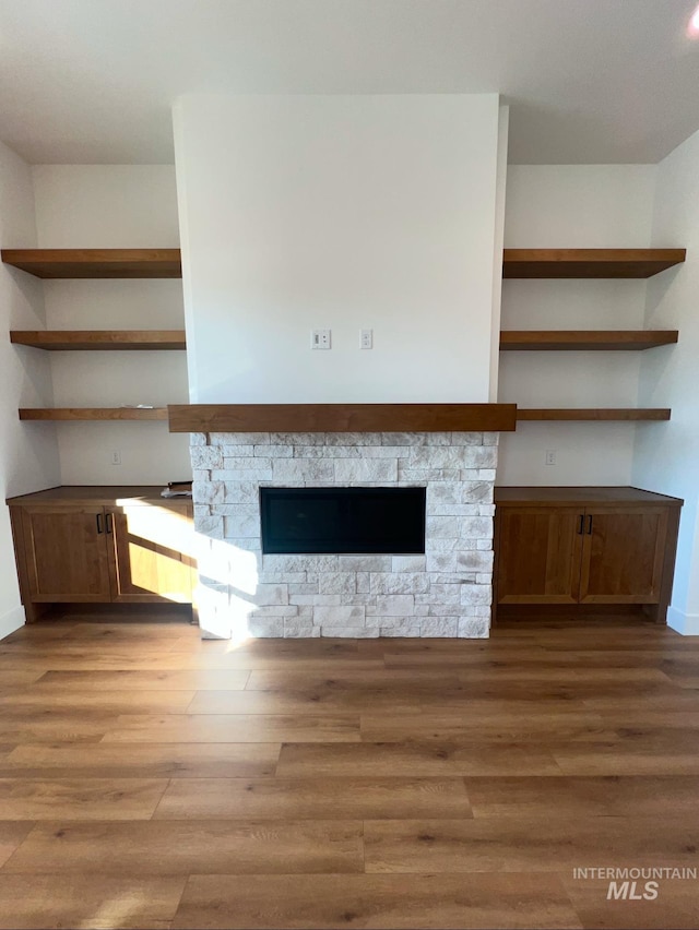11233 S Saylis Pl, Kuna, ID 83634 - unfurnished living room with a stone fireplace and light hardwood / wood-style flooring