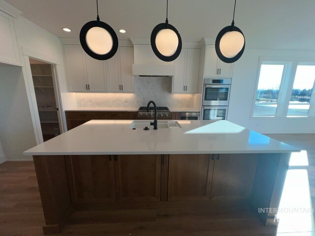 11233 S Saylis Pl, Kuna, ID 83634 - kitchen featuring sink, an island with sink, and white cabinets
