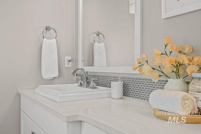 bathroom with decorative backsplash and vanity