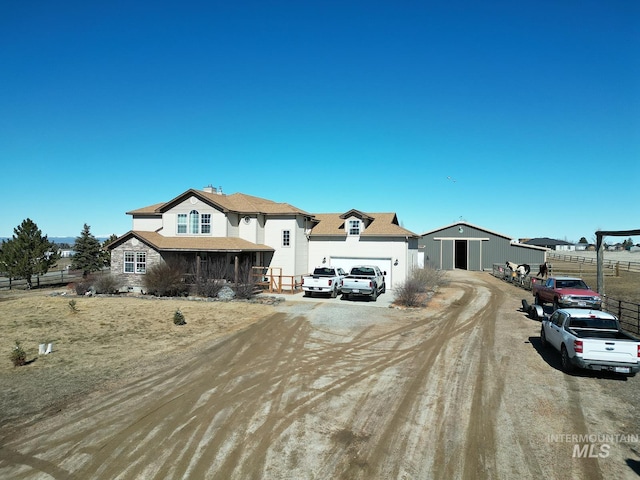 view of front of house with driveway and fence