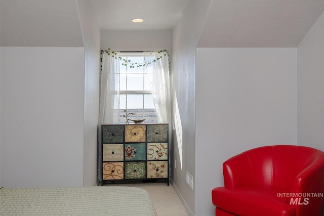 bedroom with baseboards and a textured ceiling