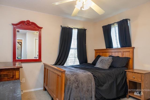 bedroom with light carpet, ceiling fan, and baseboards