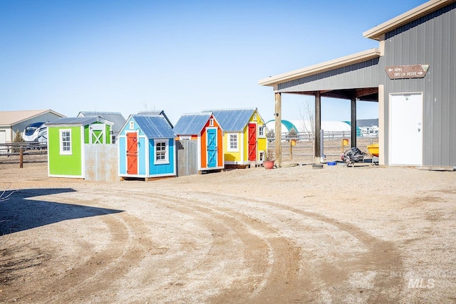 view of play area with an outbuilding, a residential view, and a storage unit