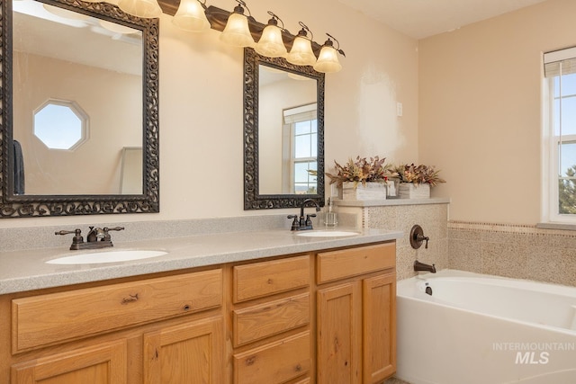 full bath with double vanity, a sink, and a bath