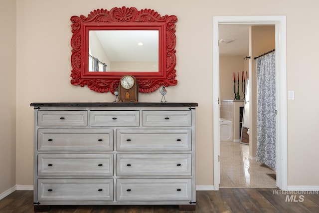 details featuring baseboards and wood finished floors