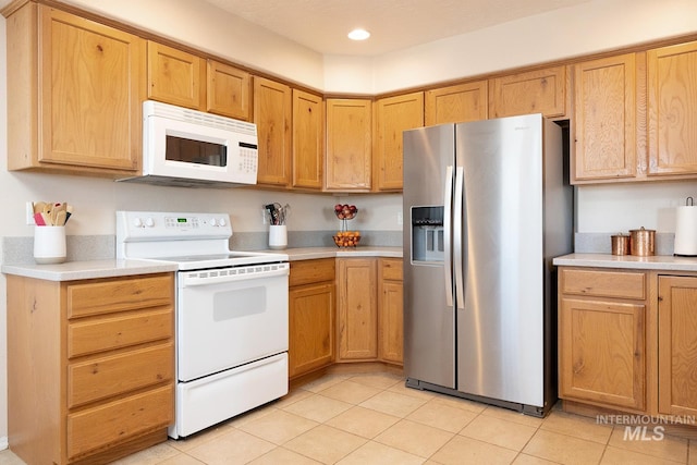 kitchen featuring light countertops, white appliances, light tile patterned flooring, and recessed lighting