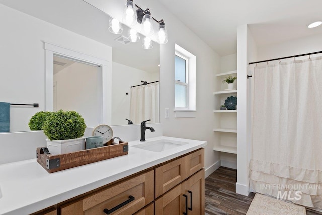 bathroom featuring visible vents, vanity, and wood finished floors