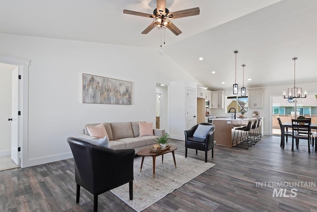 living area with baseboards, dark wood finished floors, ceiling fan with notable chandelier, high vaulted ceiling, and recessed lighting