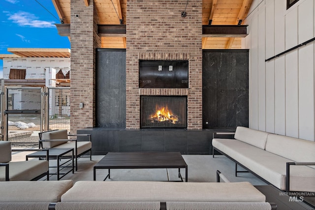 view of patio with an outdoor living space with a fireplace