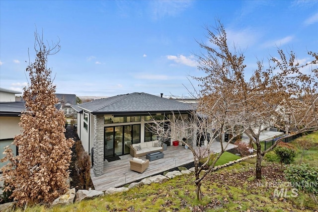 back of house featuring an outdoor living space and a wooden deck