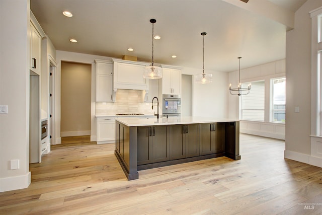 1149 E Crescendo St, Meridian, ID 83642 - kitchen with oven, light countertops, white cabinets, light wood finished floors, and recessed lighting