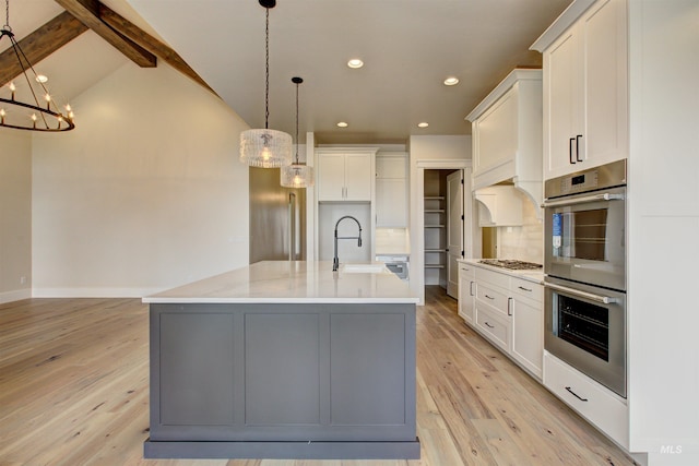 1149 E Crescendo St, Meridian, ID 83642 - kitchen with stainless steel appliances, a chandelier, light wood finished floors, recessed lighting, and light countertops