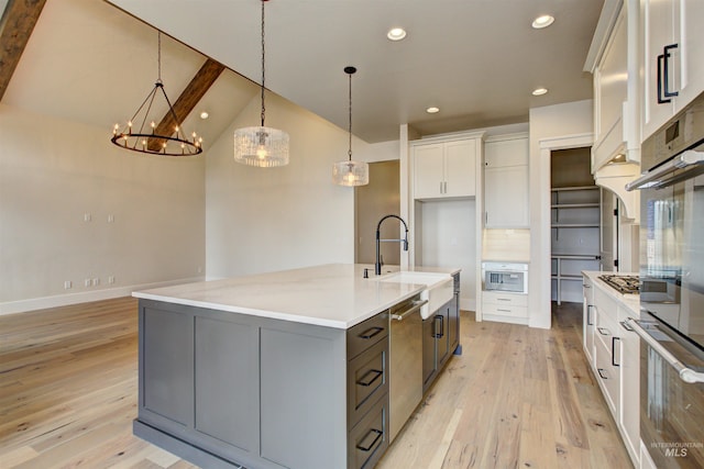 1149 E Crescendo St, Meridian, ID 83642 - kitchen with a chandelier, light wood-type flooring, white cabinets, stainless steel appliances, and recessed lighting