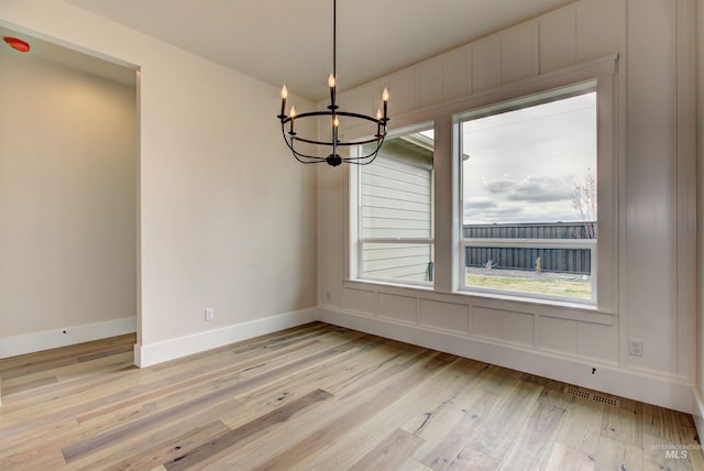 1149 E Crescendo St, Meridian, ID 83642 - unfurnished dining area featuring a chandelier and light wood-style floors
