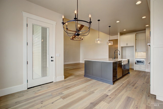 1149 E Crescendo St, Meridian, ID 83642 - kitchen featuring stainless steel dishwasher, recessed lighting, light wood-style floors, decorative light fixtures, and light countertops
