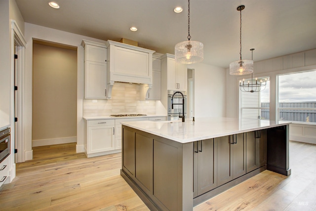 1149 E Crescendo St, Meridian, ID 83642 - kitchen featuring gas cooktop, white cabinets, decorative backsplash, light countertops, and recessed lighting