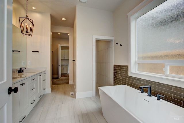 1149 E Crescendo St, Meridian, ID 83642 - bathroom featuring a soaking tub, vanity, healthy amount of natural light, a chandelier, and recessed lighting