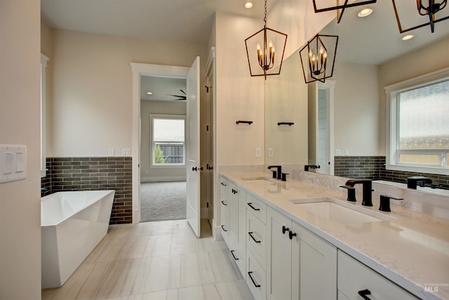1149 E Crescendo St, Meridian, ID 83642 - full bath with a freestanding tub, healthy amount of natural light, a chandelier, double vanity, and recessed lighting