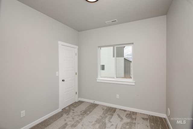 unfurnished room with light colored carpet