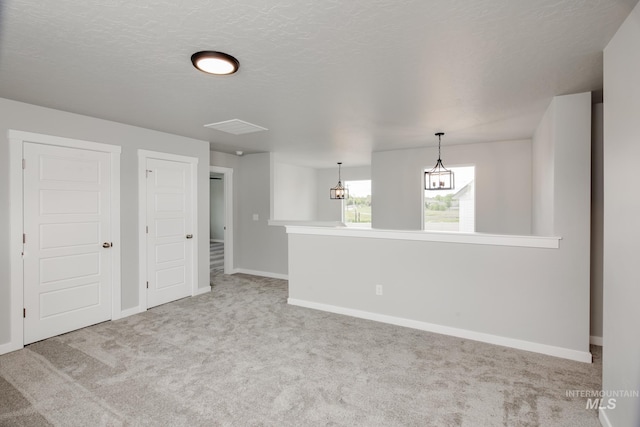 carpeted empty room with a textured ceiling