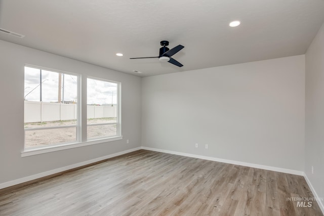 empty room featuring ceiling fan and light hardwood / wood-style floors