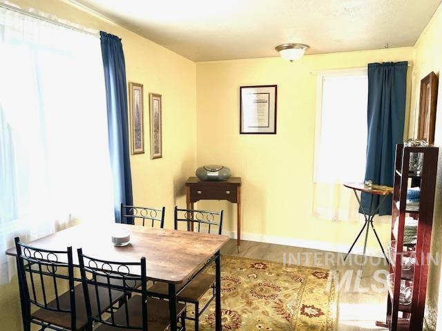 dining space with wood-type flooring