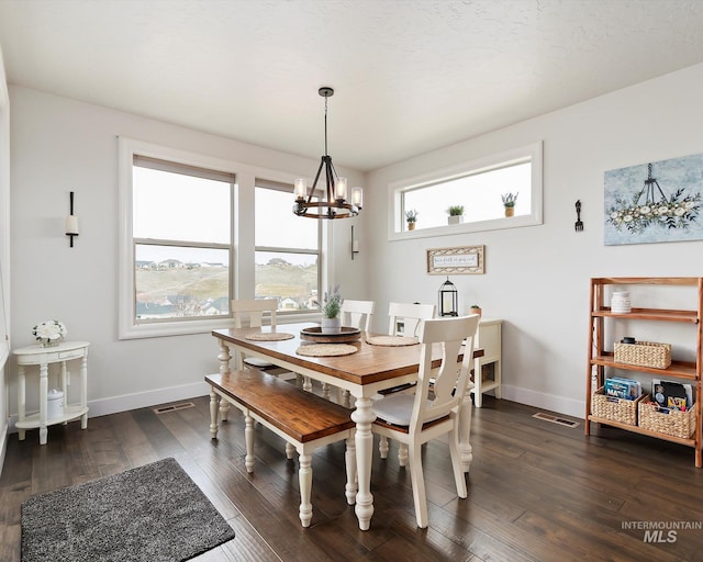 dining room with visible vents, baseboards, dark wood-type flooring, and an inviting chandelier