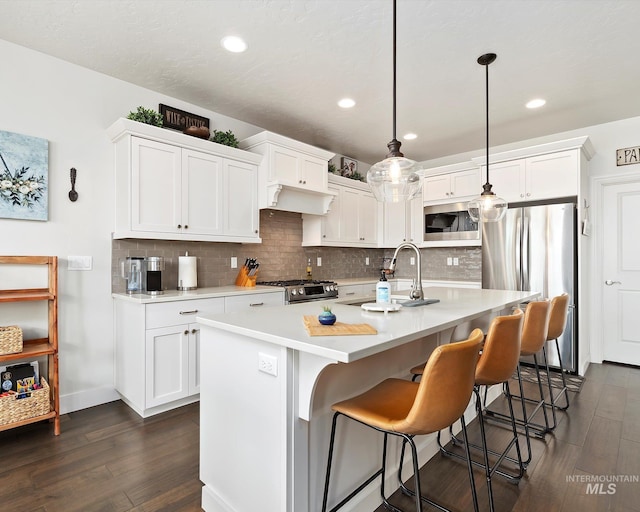 kitchen featuring white cabinetry, appliances with stainless steel finishes, and a sink