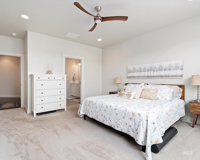 carpeted bedroom with visible vents, ensuite bathroom, recessed lighting, baseboards, and ceiling fan